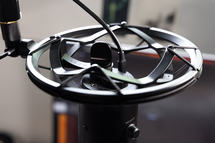 Cradling your microphone in a shock out will reduce vibrations from the desk or floor